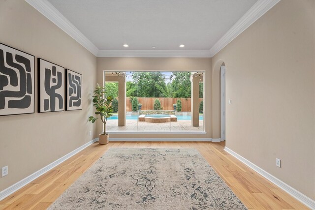 15222 Hilltop View Dr, Cypress, TX 77429 - spare room featuring arched walkways, wood finished floors, recessed lighting, and ornamental molding