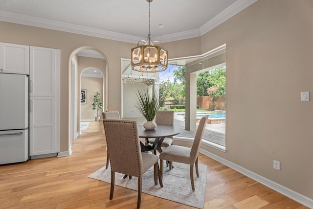 15222 Hilltop View Dr, Cypress, TX 77429 - dining area with arched walkways, a chandelier, crown molding, and light wood-style floors