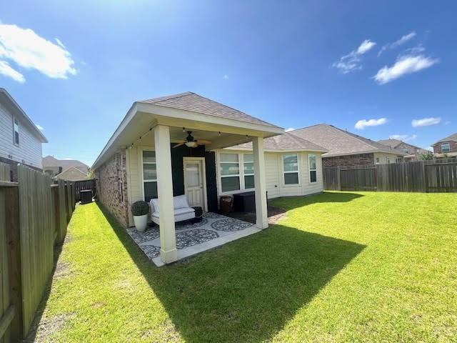 10809 Mendel Terrace Dr, Rosharon, TX 77583 - back of property with ceiling fan and a patio area