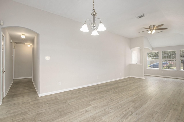 19238 Augusta Mist Ln, Katy, TX 77449 - spare room featuring arched walkways, ceiling fan, light wood finished floors, baseboards, and lofted ceiling