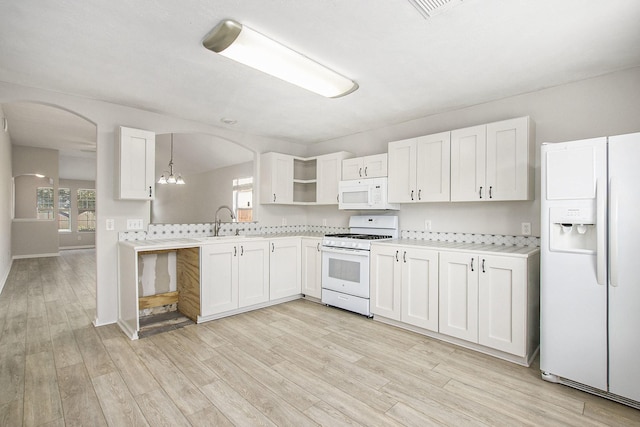 19238 Augusta Mist Ln, Katy, TX 77449 - kitchen with white appliances, arched walkways, light wood-type flooring, and open shelves