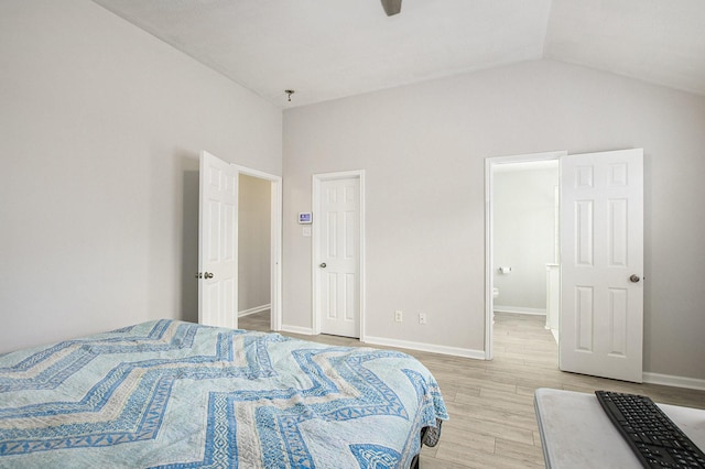 19238 Augusta Mist Ln, Katy, TX 77449 - bedroom with light wood finished floors, lofted ceiling, baseboards, and ensuite bathroom