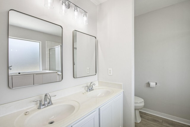 19238 Augusta Mist Ln, Katy, TX 77449 - full bathroom with toilet, double vanity, wood finished floors, baseboards, and a shower