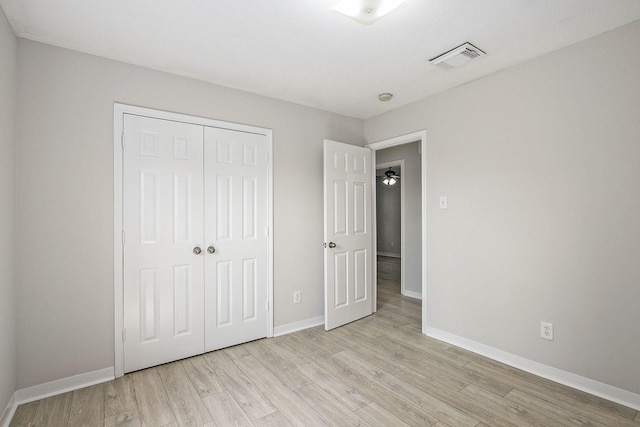 19238 Augusta Mist Ln, Katy, TX 77449 - unfurnished bedroom with light wood-style flooring, a closet, and baseboards