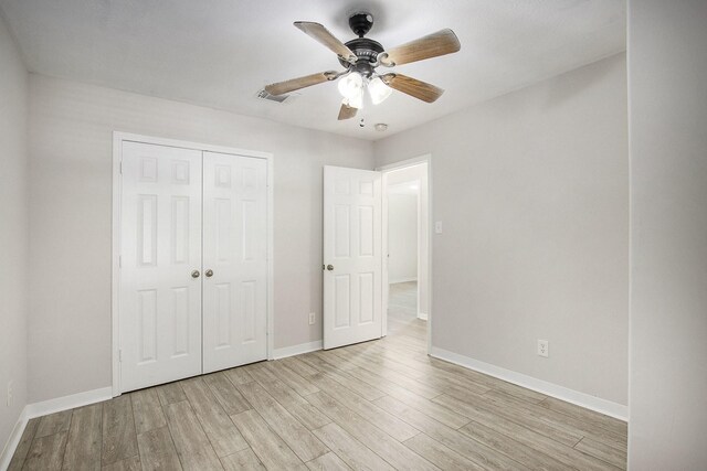 19238 Augusta Mist Ln, Katy, TX 77449 - unfurnished bedroom featuring light wood-style flooring, a closet, baseboards, and a ceiling fan