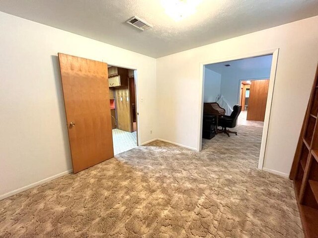 302 Cordell Dr, Crockett, TX 75835 - carpeted spare room with baseboards and a textured ceiling