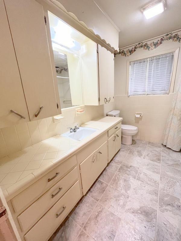 302 Cordell Dr, Crockett, TX 75835 - bathroom featuring vanity, toilet, and tile patterned floors