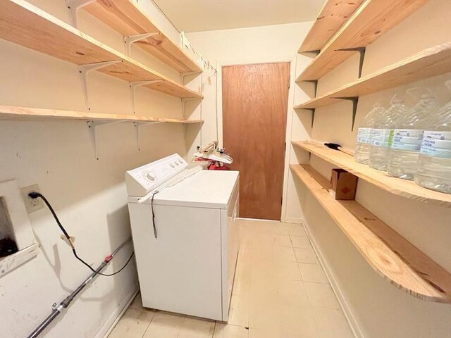 302 Cordell Dr, Crockett, TX 75835 - laundry room with washer / clothes dryer and light tile patterned flooring