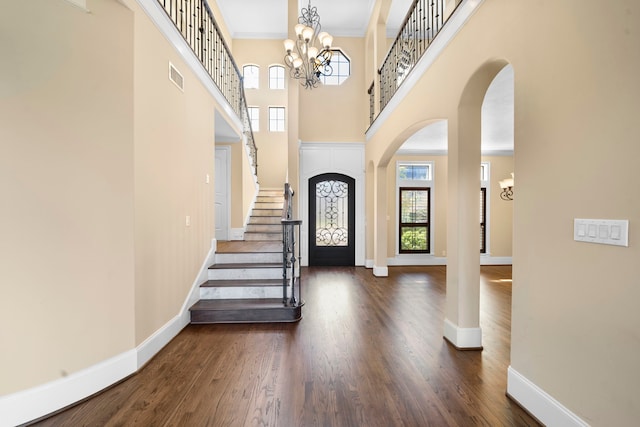 4628 Beech St, Bellaire, TX 77401 - entryway featuring stairs, baseboards, arched walkways, dark wood finished floors, and a towering ceiling