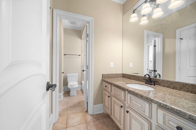 4628 Beech St, Bellaire, TX 77401 - bathroom featuring vanity, toilet, tile patterned floors, a chandelier, and baseboards