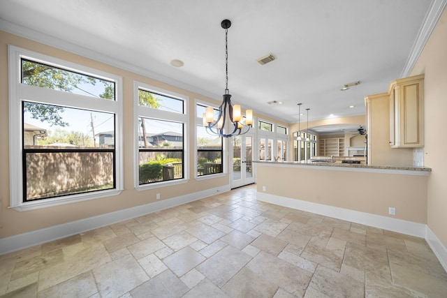 4628 Beech St, Bellaire, TX 77401 - kitchen with healthy amount of natural light, stone tile floors, crown molding, baseboards, and a chandelier