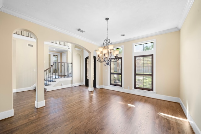 4628 Beech St, Bellaire, TX 77401 - spare room with arched walkways, crown molding, a chandelier, wood finished floors, and stairs