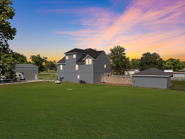 3525 N Morning Glory Dr, Santa Fe, TX 77517 - back of property at dusk featuring an outdoor structure