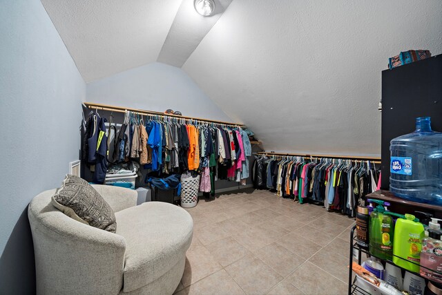 3525 N Morning Glory Dr, Santa Fe, TX 77517 - spacious closet featuring vaulted ceiling and tile patterned flooring