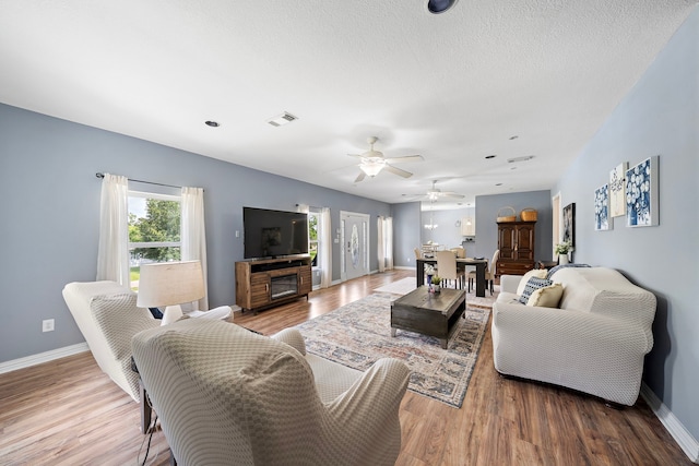 3525 N Morning Glory Dr, Santa Fe, TX 77517 - living room featuring baseboards, wood finished floors, and ceiling fan