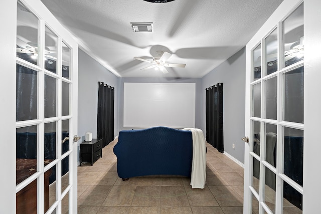 3525 N Morning Glory Dr, Santa Fe, TX 77517 - living room featuring french doors, ceiling fan, tile patterned flooring, and a textured ceiling