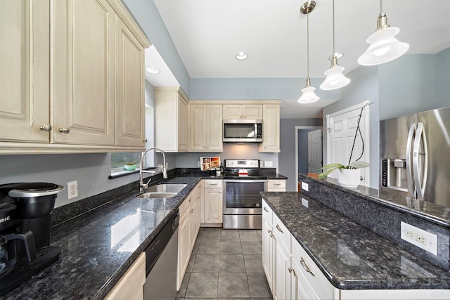 3525 N Morning Glory Dr, Santa Fe, TX 77517 - kitchen featuring stainless steel appliances, a sink, tile patterned floors, hanging light fixtures, and dark stone counters