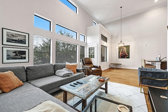 4402 Lillian St Unit 8, Houston, TX 77007 - living room featuring a high ceiling, light wood-type flooring, crown molding, and baseboards