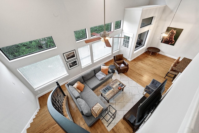 4402 Lillian St Unit 8, Houston, TX 77007 - living area with a towering ceiling, healthy amount of natural light, wood finished floors, baseboards, and a ceiling fan