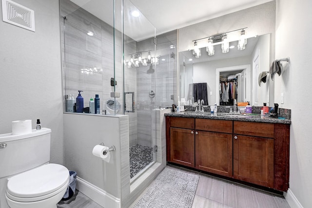 4402 Lillian St Unit 8, Houston, TX 77007 - bathroom featuring toilet, vanity, a shower stall, a spacious closet, and baseboards