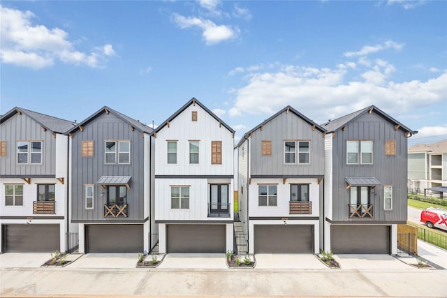 1941 Johanna Dr, Houston, TX 77055 - townhome / multi-family property featuring a garage, board and batten siding, and driveway