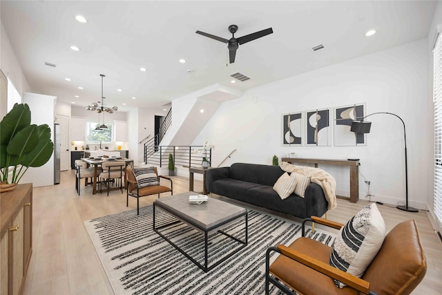 1941 Johanna Dr, Houston, TX 77055 - living area with a ceiling fan, recessed lighting, stairway, light wood-type flooring, and a chandelier