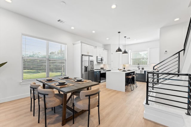 1941 Johanna Dr, Houston, TX 77055 - dining room featuring stairs, light wood-style flooring, recessed lighting, and baseboards
