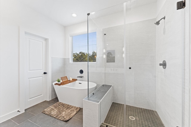 1941 Johanna Dr, Houston, TX 77055 - bathroom featuring tile patterned flooring, a stall shower, a freestanding tub, and tile walls