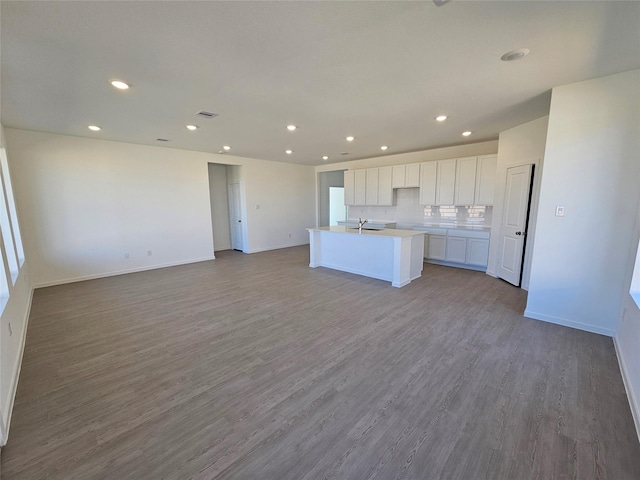 10623 Autumn Trace Dr, Beasley, TX 77417 - kitchen with white cabinets, recessed lighting, an island with sink, open floor plan, and a sink