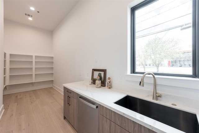 5008 Holt St, Bellaire, TX 77401 - kitchen featuring a sink, dishwasher, healthy amount of natural light, and light wood-style floors