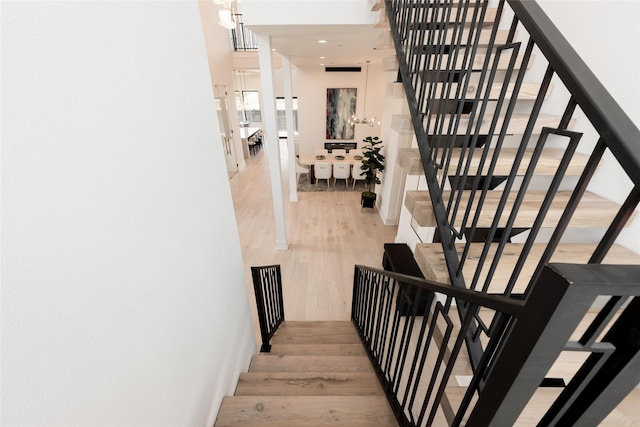 5008 Holt St, Bellaire, TX 77401 - stairs with wood finished floors and recessed lighting
