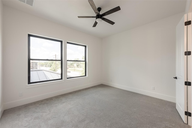 5008 Holt St, Bellaire, TX 77401 - unfurnished room with carpet flooring, baseboards, and ceiling fan