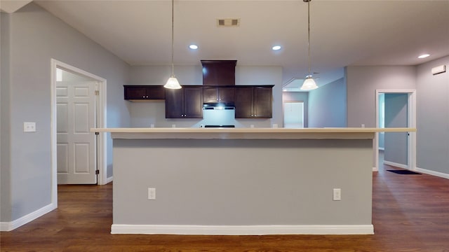 2405 Dolly Wright St, Houston, TX 77088 - kitchen with dark brown cabinetry, dark wood-style floors, light countertops, baseboards, and pendant lighting