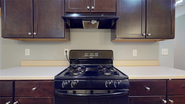 2405 Dolly Wright St, Houston, TX 77088 - kitchen with black gas range oven, exhaust hood, light countertops, and dark brown cabinetry