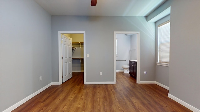 2405 Dolly Wright St, Houston, TX 77088 - unfurnished bedroom featuring wood finished floors, a spacious closet, and baseboards