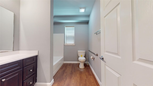 2405 Dolly Wright St, Houston, TX 77088 - bathroom featuring vanity, toilet, wood finished floors, a tub, and baseboards
