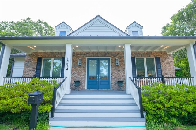10614 Moonlight Dr, Houston, TX 77096 - entrance to property featuring covered porch and french doors