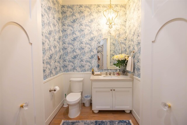 10614 Moonlight Dr, Houston, TX 77096 - bathroom with toilet, wainscoting, wood finished floors, vanity, and a chandelier