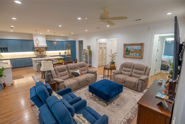 10614 Moonlight Dr, Houston, TX 77096 - living room featuring light wood-style floors, ceiling fan, and recessed lighting