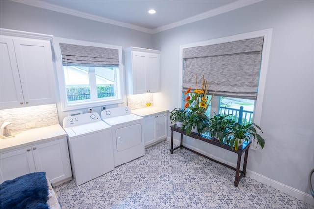 10614 Moonlight Dr, Houston, TX 77096 - laundry room with cabinet space, washing machine and dryer, light flooring, crown molding, and baseboards