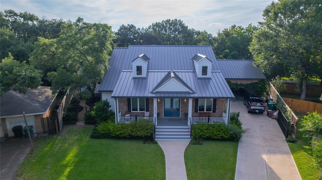 10614 Moonlight Dr, Houston, TX 77096 - view of front of house with a standing seam roof, brick siding, a porch, and driveway