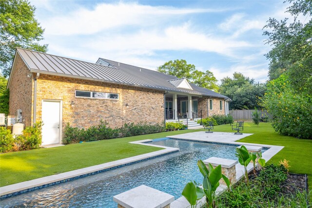 10614 Moonlight Dr, Houston, TX 77096 - rear view of property featuring a standing seam roof, brick siding, and metal roof