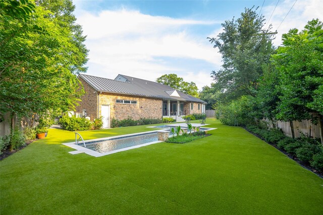 10614 Moonlight Dr, Houston, TX 77096 - back of house featuring a standing seam roof, metal roof, and stone siding