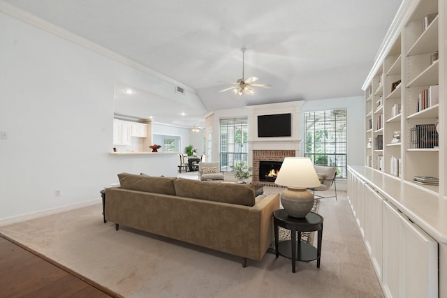 18107 Hampton Oak Dr, Spring, TX 77379 - living room with ceiling fan, a brick fireplace, vaulted ceiling, light wood-type flooring, and ornamental molding