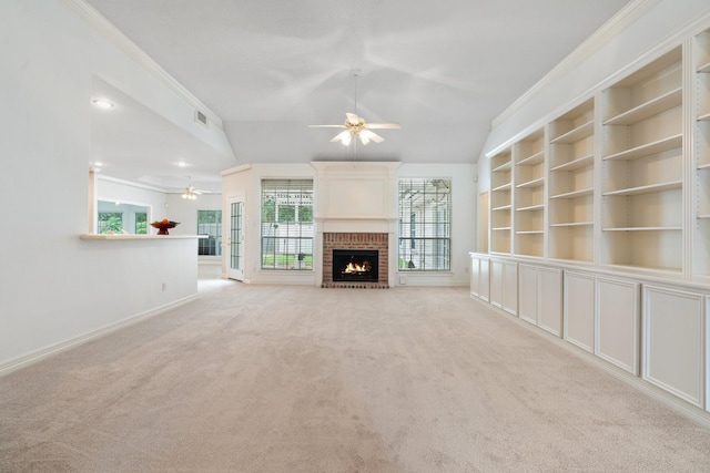 18107 Hampton Oak Dr, Spring, TX 77379 - unfurnished living room featuring a ceiling fan, carpet floors, a fireplace, crown molding, and built in shelves
