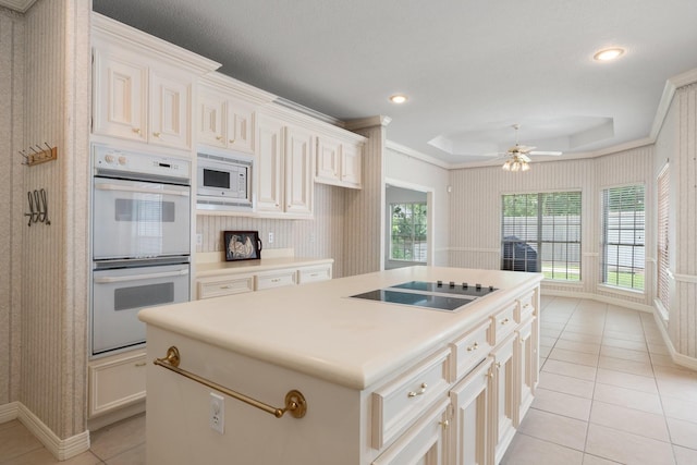 18107 Hampton Oak Dr, Spring, TX 77379 - kitchen featuring white appliances, light tile patterned floors, ceiling fan, a kitchen island, and recessed lighting