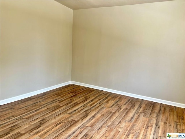 515 Mitchell Ave, Seguin, TX 78155 - empty room with baseboards and wood finished floors
