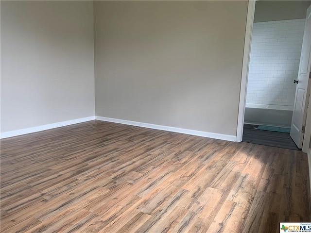 515 Mitchell Ave, Seguin, TX 78155 - spare room featuring dark wood-style floors and baseboards