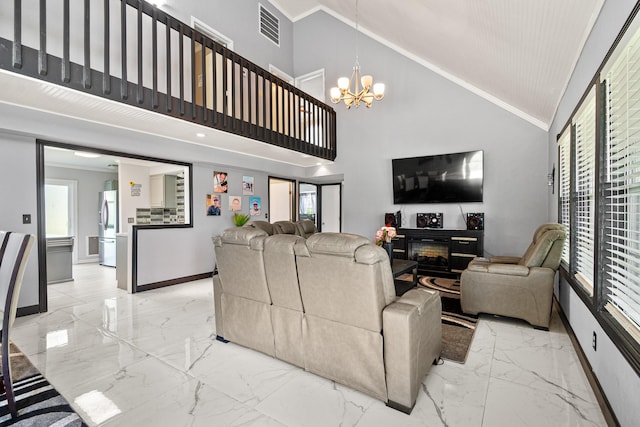 20 Clearview St, Point Blank, TX 77364 - living area featuring light marble finish floors, baseboards, a chandelier, crown molding, and a glass covered fireplace