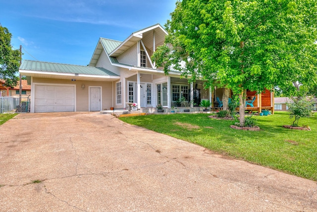20 Clearview St, Point Blank, TX 77364 - view of front of property featuring a garage, driveway, a porch, and metal roof